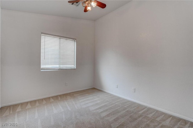 empty room with ceiling fan, light carpet, and baseboards