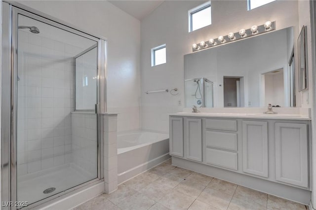bathroom featuring a shower stall, a bath, tile patterned floors, and double vanity
