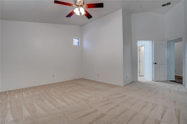 unfurnished room with light carpet, ceiling fan, and baseboards