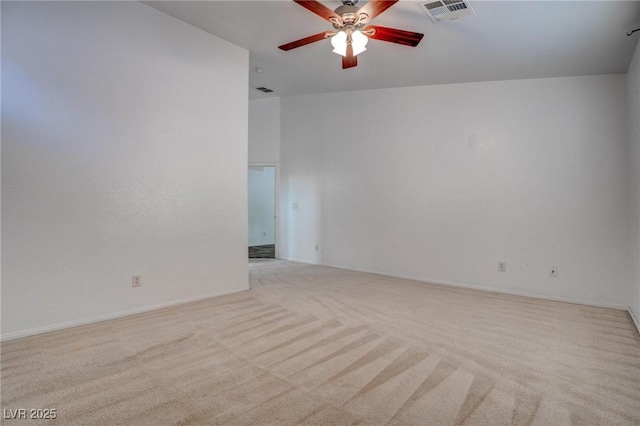 spare room featuring carpet and a ceiling fan