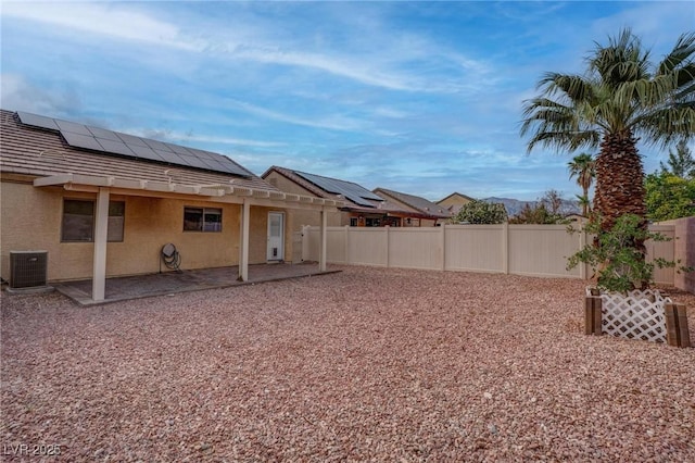 fenced backyard with a patio and central air condition unit