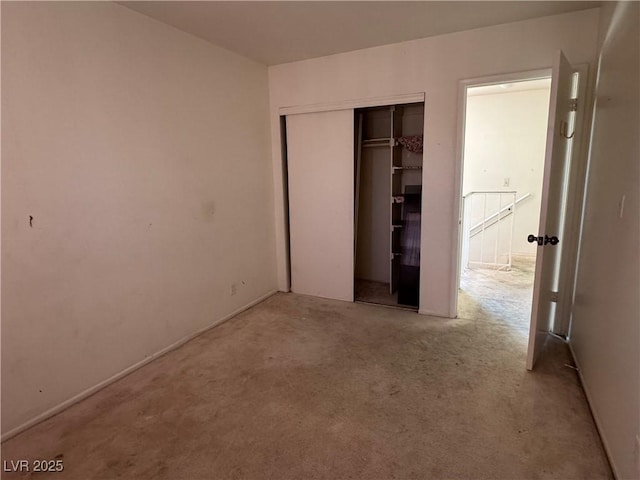unfurnished bedroom featuring carpet and a closet