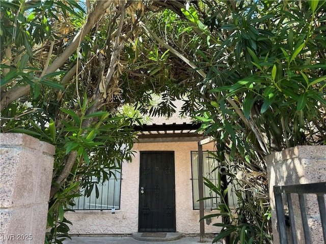 property entrance with stucco siding