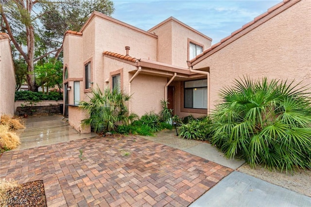 view of side of property with stucco siding