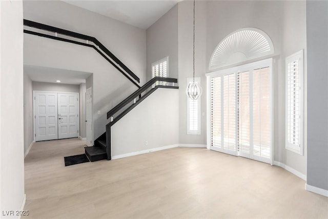 3246 Brookfield Dr, Las Vegas, NV 89120 - entrance foyer featuring a high ceiling, healthy amount of natural light, stairway, and wood finished floors