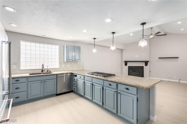 3246 Brookfield Dr, Las Vegas, NV 89120 - kitchen featuring stainless steel appliances, a sink, light wood-style flooring, a peninsula, and decorative backsplash