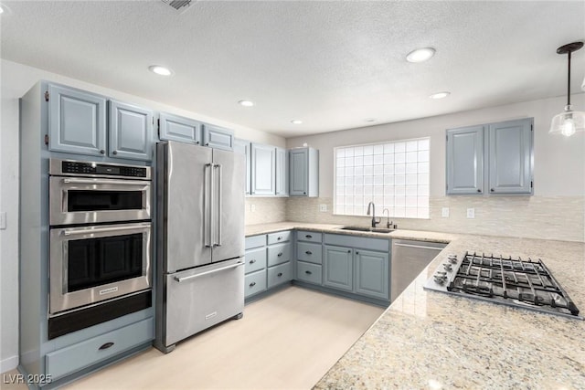 3246 Brookfield Dr, Las Vegas, NV 89120 - kitchen featuring stainless steel appliances, a sink, backsplash, a textured ceiling, and recessed lighting