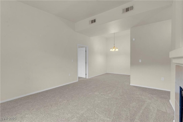 unfurnished living room with a chandelier, carpet flooring, a fireplace, and baseboards