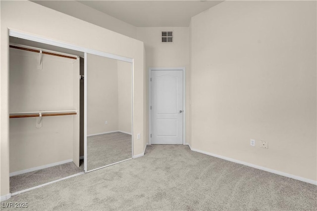 unfurnished bedroom featuring carpet floors, baseboards, and a closet
