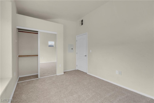 unfurnished bedroom with carpet floors, a closet, and baseboards