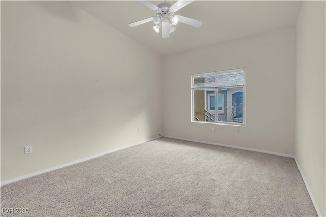 empty room with carpet, a ceiling fan, and baseboards