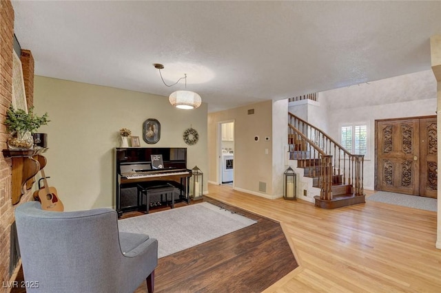1700 Red Rock St, Las Vegas, NV 89146 - living area featuring stairway, wood finished floors, and baseboards