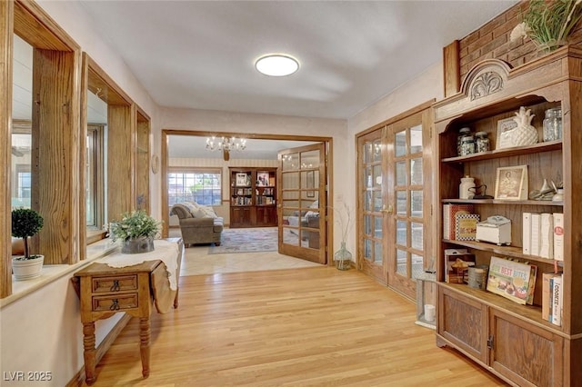 1700 Red Rock St, Las Vegas, NV 89146 - corridor with light wood-style floors, french doors, and a chandelier