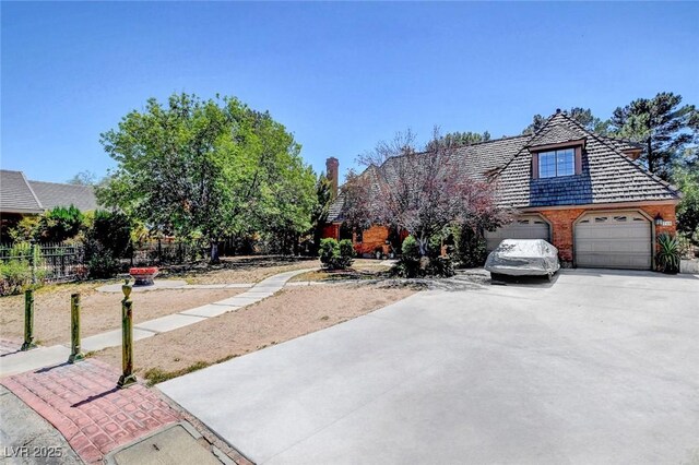 1700 Red Rock St, Las Vegas, NV 89146 - view of front of home with concrete driveway, fence, brick siding, and a garage