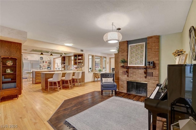 1700 Red Rock St, Las Vegas, NV 89146 - living area with light wood-type flooring and a brick fireplace