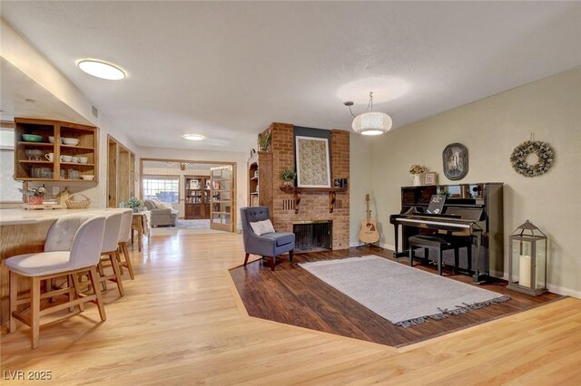 1700 Red Rock St, Las Vegas, NV 89146 - living room featuring light wood-type flooring, a fireplace, and baseboards