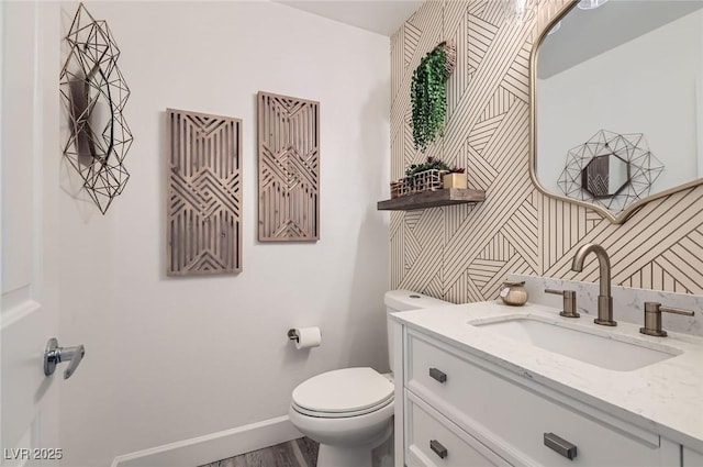 2470 Lower Meadows Ave, Henderson, NV 89052 - half bathroom featuring toilet, vanity, baseboards, and wood finished floors