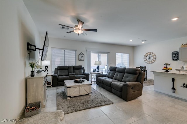 living area with a ceiling fan, light tile patterned floors, recessed lighting, and baseboards