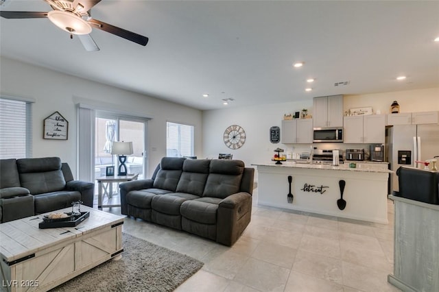 living area with ceiling fan, recessed lighting, and light tile patterned flooring