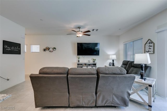 living area featuring a ceiling fan and light tile patterned floors