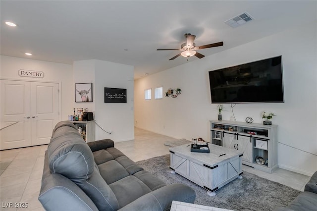 living room with a ceiling fan, light tile patterned floors, and recessed lighting