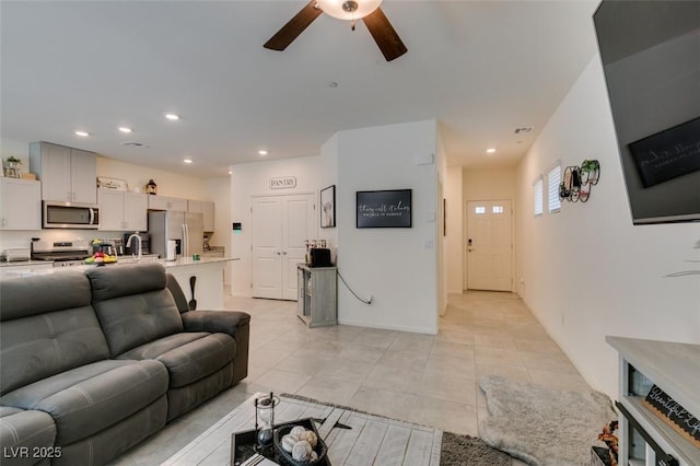 living room featuring a ceiling fan, light tile patterned flooring, and recessed lighting