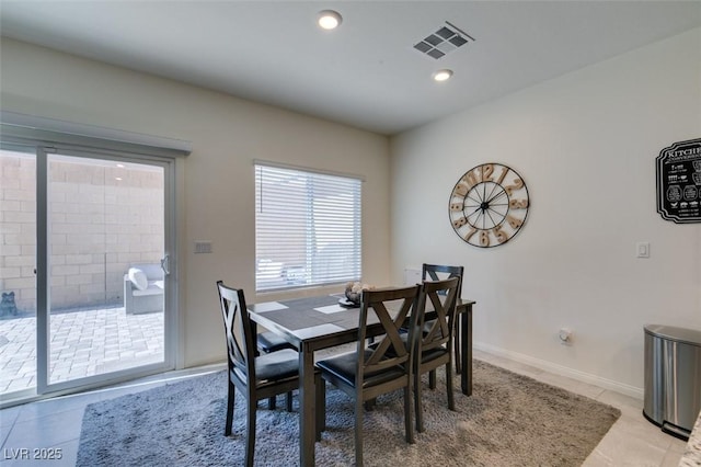 dining space featuring light tile patterned flooring, recessed lighting, and baseboards