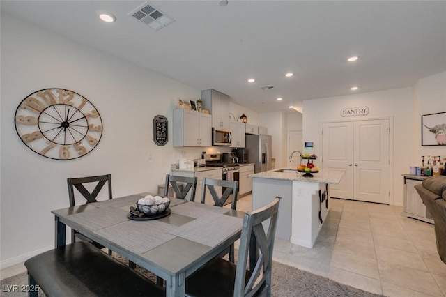 dining room featuring recessed lighting and light tile patterned flooring