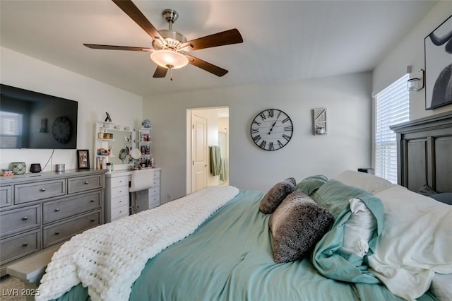 bedroom with ceiling fan and connected bathroom