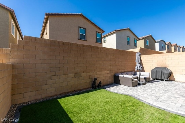 fenced backyard featuring a patio and an outdoor hangout area