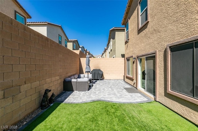 fenced backyard with a patio area