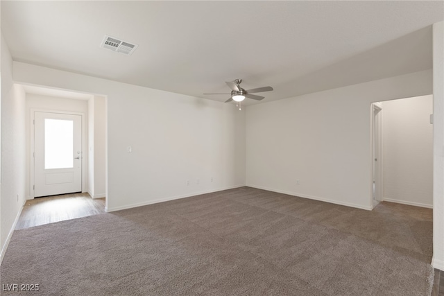 empty room featuring carpet floors, ceiling fan, and baseboards