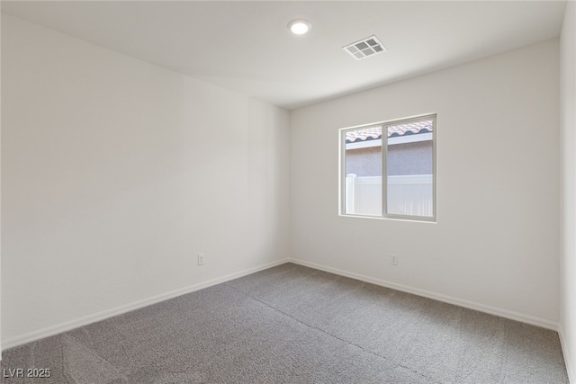 empty room featuring carpet flooring, baseboards, and recessed lighting