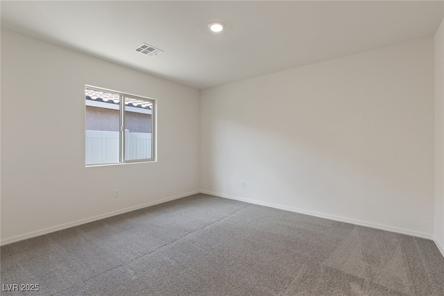 carpeted spare room with baseboards
