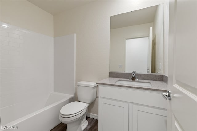 full bathroom with toilet, wood finished floors, vanity, baseboards, and  shower combination