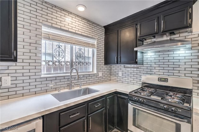 kitchen featuring gas range, a sink, ventilation hood, decorative backsplash, and beverage cooler
