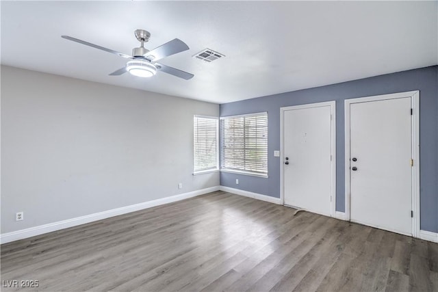 foyer featuring ceiling fan, wood finished floors, and baseboards