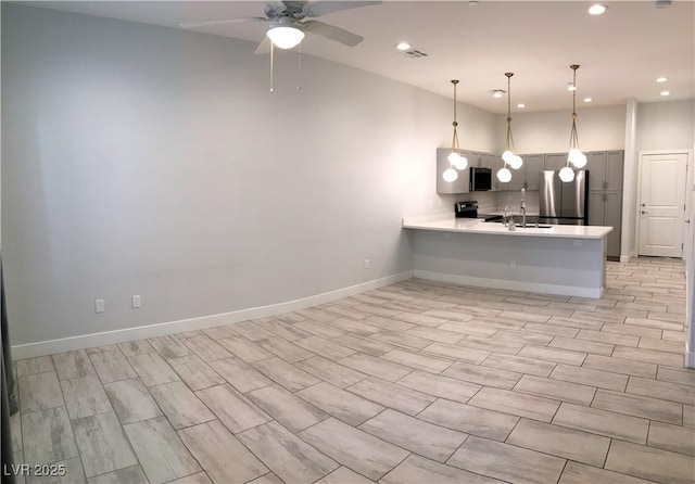 kitchen featuring a peninsula, visible vents, light countertops, appliances with stainless steel finishes, and recessed lighting