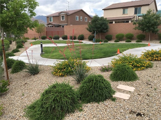 exterior space featuring a lawn and fence