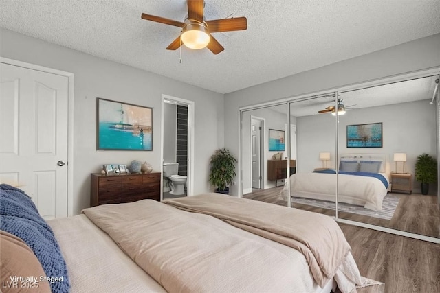 1112 Observation Dr Unit 201, Las Vegas, NV 89128 - bedroom with wood finished floors, a textured ceiling, a ceiling fan, ensuite bathroom, and a closet