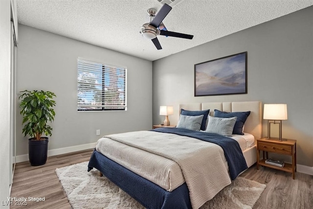 1112 Observation Dr Unit 201, Las Vegas, NV 89128 - bedroom featuring wood finished floors, a ceiling fan, and a textured ceiling