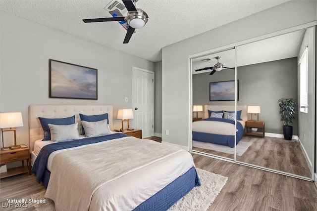 1112 Observation Dr Unit 201, Las Vegas, NV 89128 - bedroom with wood finished floors, a closet, ceiling fan, and a textured ceiling
