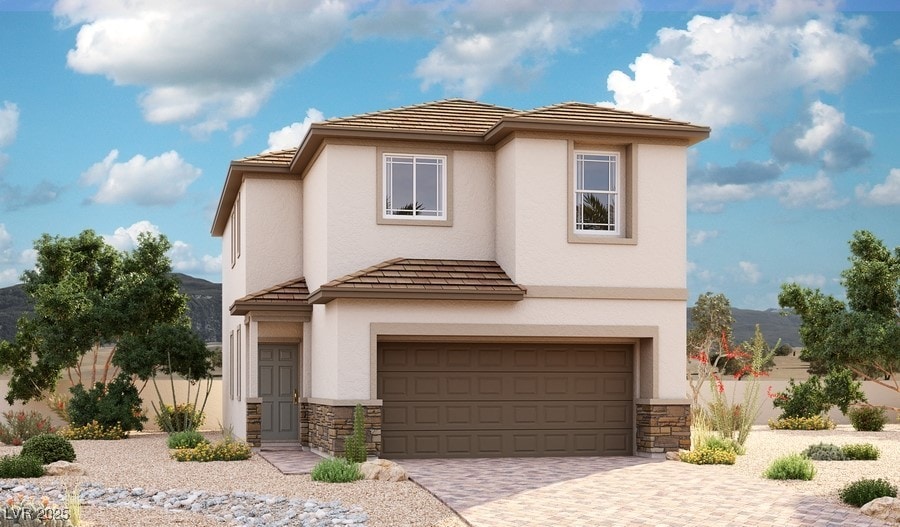 view of front of property with stone siding, an attached garage, driveway, and stucco siding