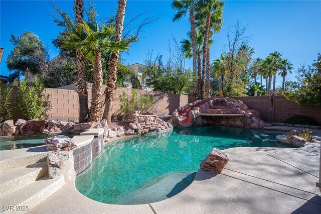 view of swimming pool with a fenced backyard
