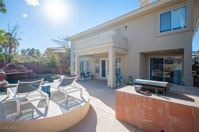 view of patio / terrace with a balcony and fence