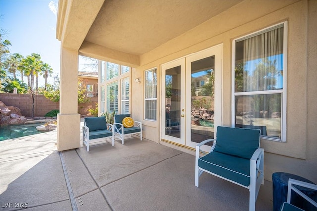 view of patio featuring french doors and fence
