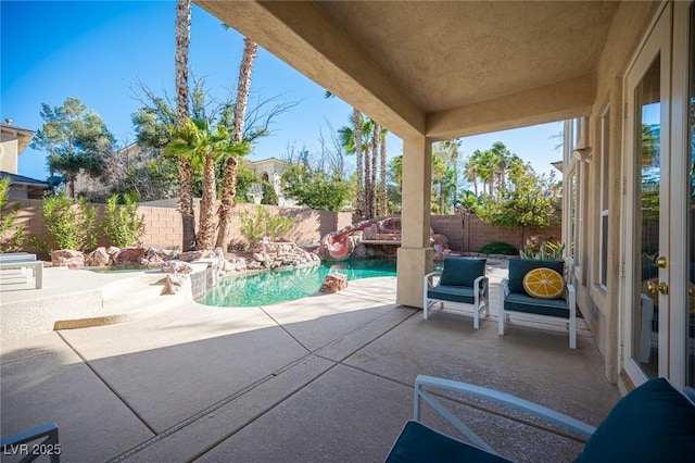 view of swimming pool with a patio area and a fenced backyard