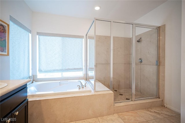 bathroom featuring a shower stall, a garden tub, vanity, and recessed lighting