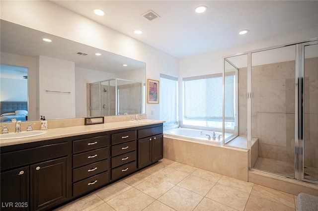 full bathroom featuring a shower stall, double vanity, a garden tub, tile patterned flooring, and recessed lighting