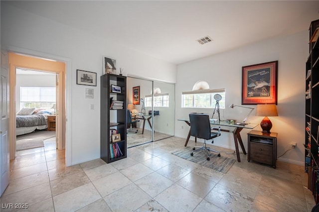 office with plenty of natural light and baseboards